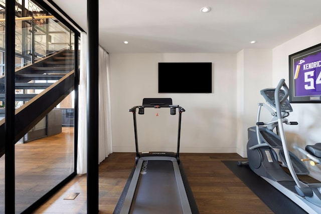 exercise room featuring recessed lighting, baseboards, and wood finished floors