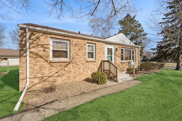 view of front of house with brick siding and a front yard