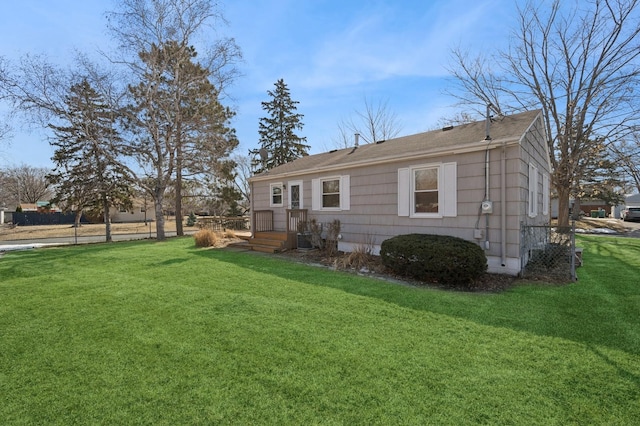 rear view of property featuring a lawn