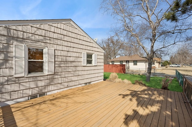 wooden terrace featuring fence and a lawn