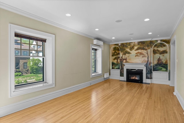 unfurnished living room featuring plenty of natural light, light wood-style floors, crown molding, a wall mounted AC, and recessed lighting