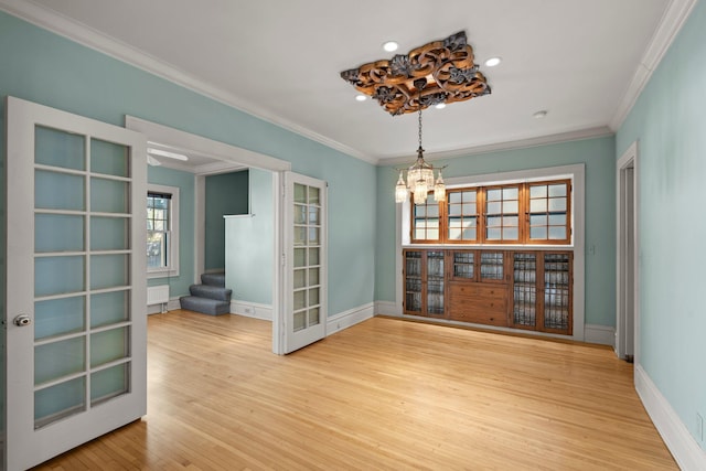 unfurnished dining area with ornamental molding, light wood-type flooring, a chandelier, stairway, and recessed lighting