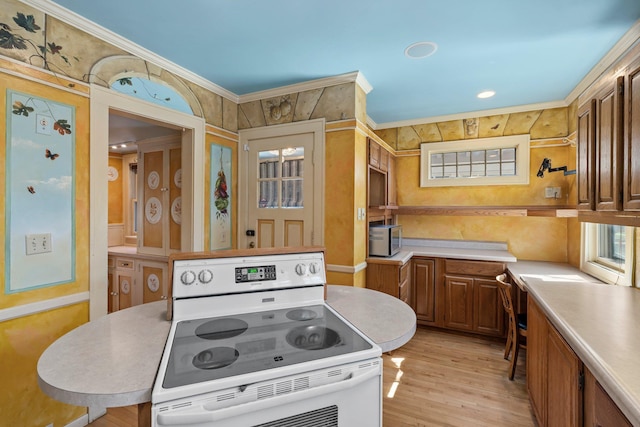 kitchen featuring electric range, light wood-type flooring, light countertops, ornamental molding, and brown cabinets
