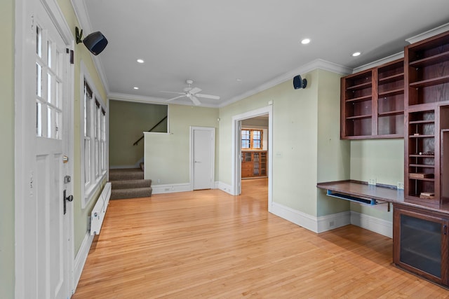 unfurnished office with a baseboard heating unit, baseboards, light wood-style floors, recessed lighting, and ornamental molding