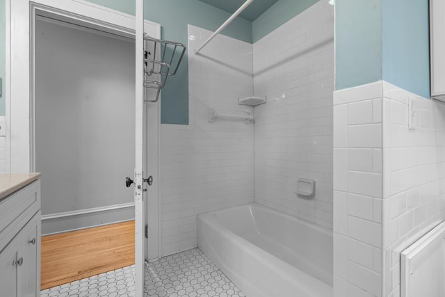 bathroom featuring tub / shower combination, vanity, and tile patterned floors