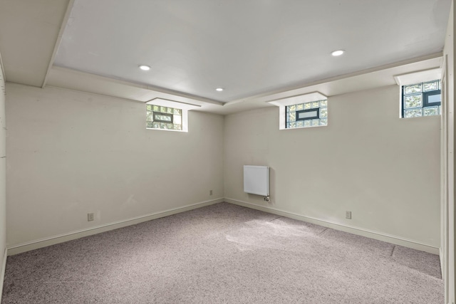 below grade area featuring healthy amount of natural light, carpet, recessed lighting, and baseboards