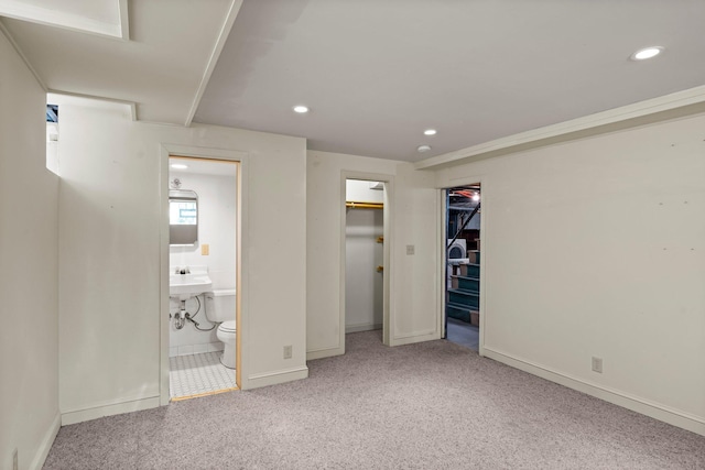 unfurnished bedroom with recessed lighting, baseboards, carpet, and ensuite bath