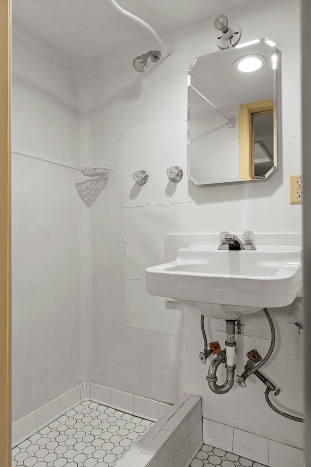 bathroom with a shower and tile patterned flooring