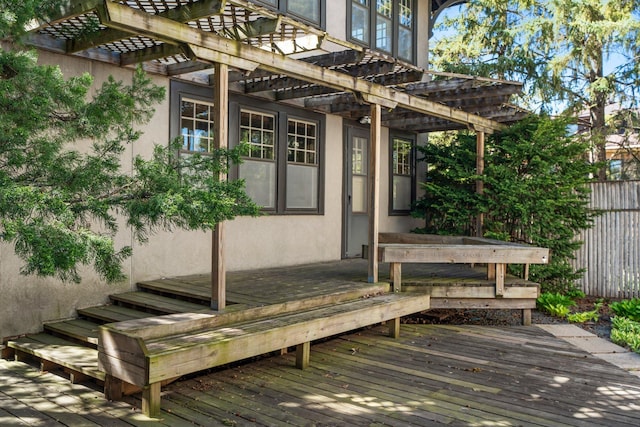 deck featuring a pergola and fence