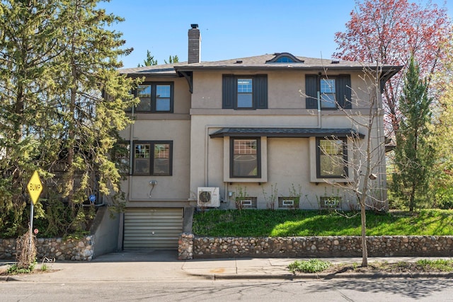 view of front of property with stucco siding, an attached garage, driveway, a chimney, and a cooling unit