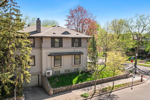 view of home's exterior featuring a chimney, roof with shingles, stucco siding, driveway, and an attached garage