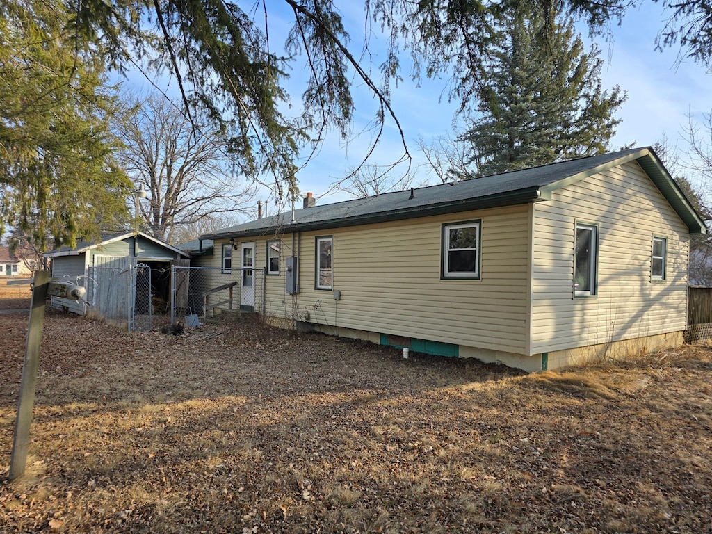 back of house with fence