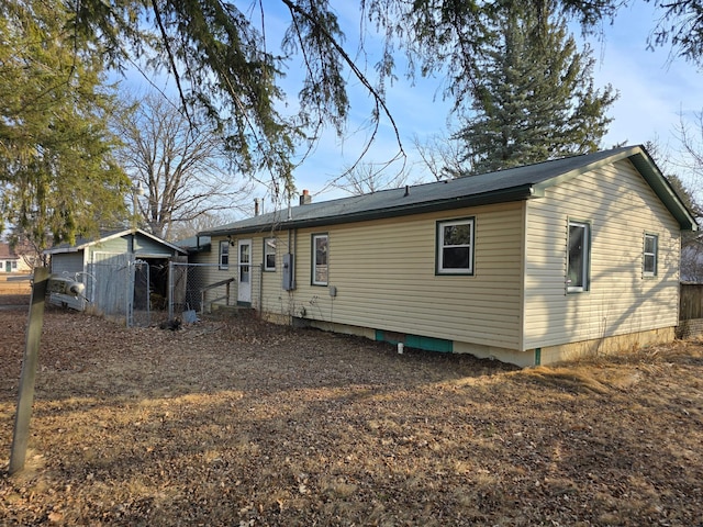 rear view of property with fence