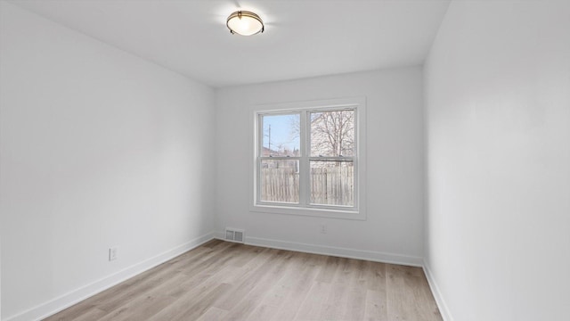 unfurnished room featuring light wood-style floors, baseboards, and visible vents