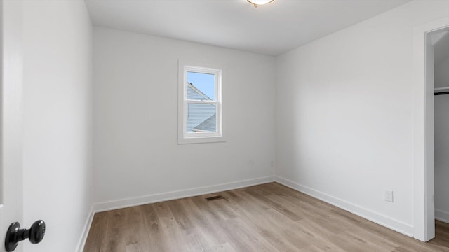 unfurnished room with visible vents, baseboards, and light wood finished floors