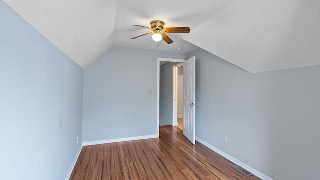 bonus room with visible vents, a textured ceiling, wood finished floors, baseboards, and ceiling fan