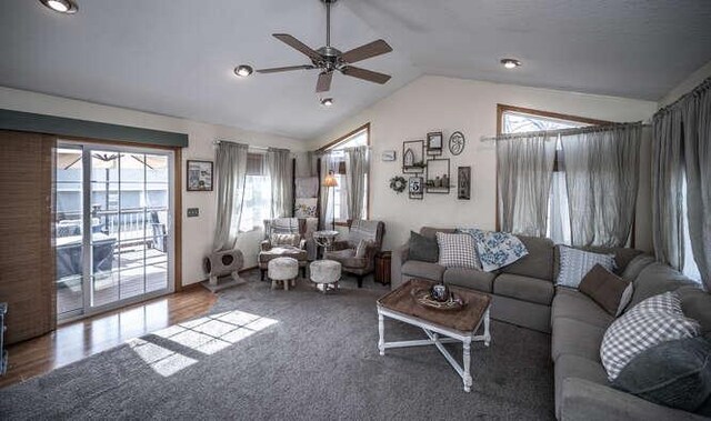 living room featuring vaulted ceiling and ceiling fan