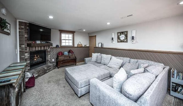 living room with recessed lighting, a fireplace, carpet floors, and wainscoting