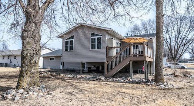 back of house featuring a deck and stairway