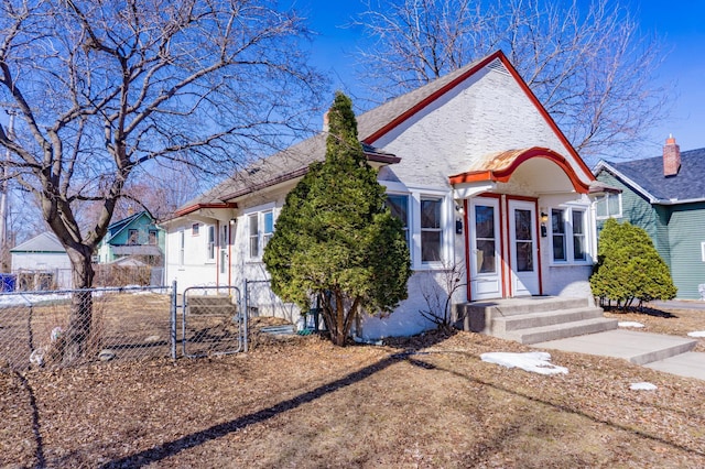 view of front of property with brick siding, a gate, and fence