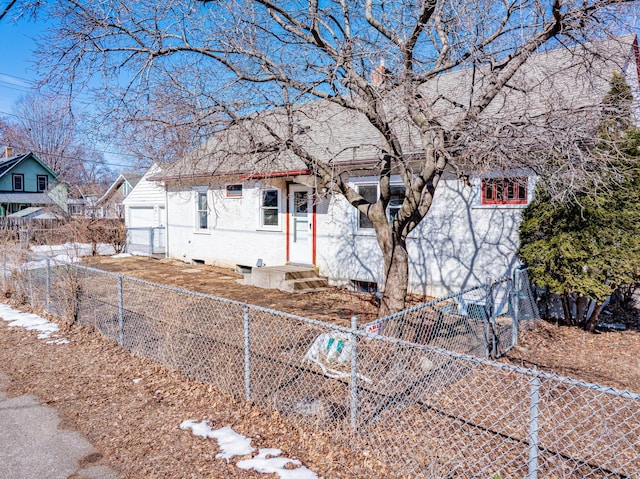 view of front facade with entry steps and a fenced front yard