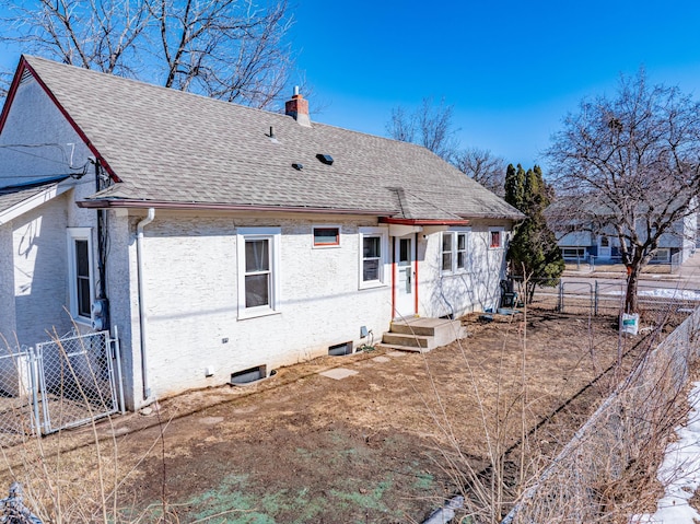 view of front of property with a gate, fence, a chimney, and a shingled roof