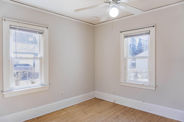 spare room with baseboards, a ceiling fan, and light wood finished floors