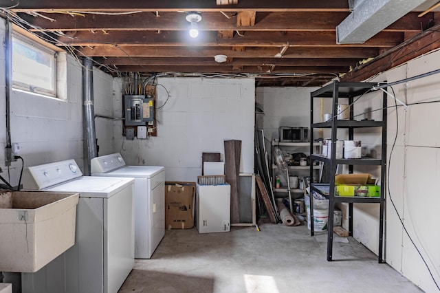 below grade area with electric panel, washer and dryer, and a sink