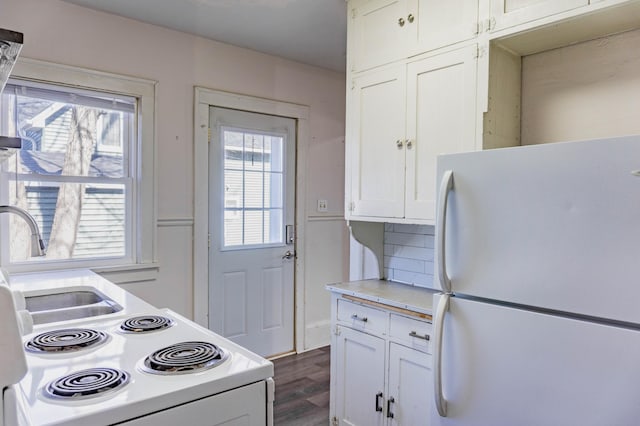 kitchen featuring light countertops, decorative backsplash, dark wood-style floors, white cabinets, and white appliances