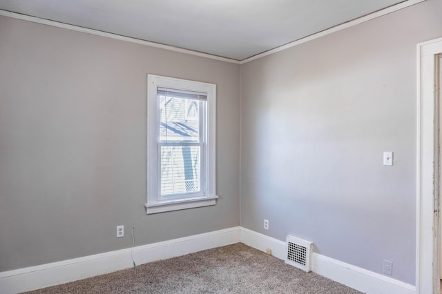 carpeted empty room featuring baseboards, visible vents, and ornamental molding