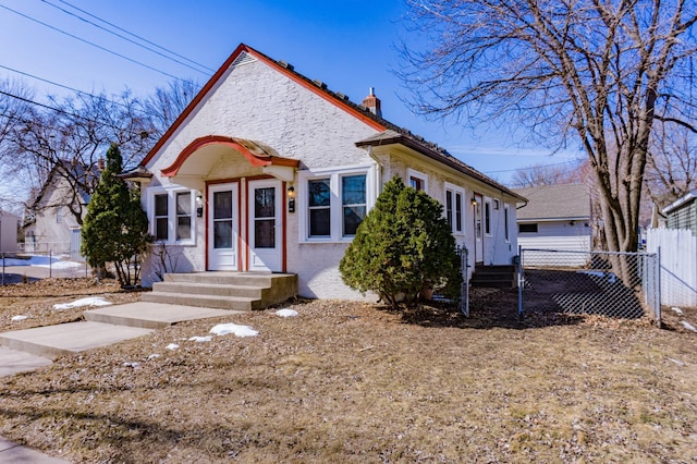 view of front of property with a chimney and fence