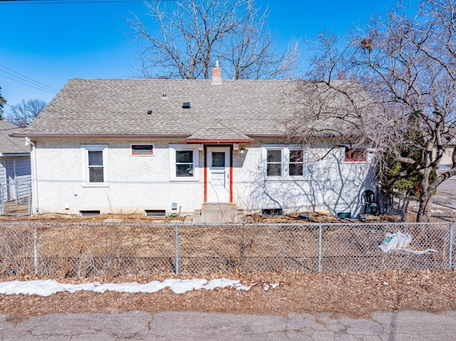 view of front of home featuring a fenced front yard, roof with shingles, and a chimney