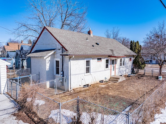 back of property with fence, roof with shingles, stucco siding, a chimney, and a gate