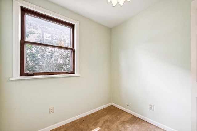 carpeted spare room with baseboards