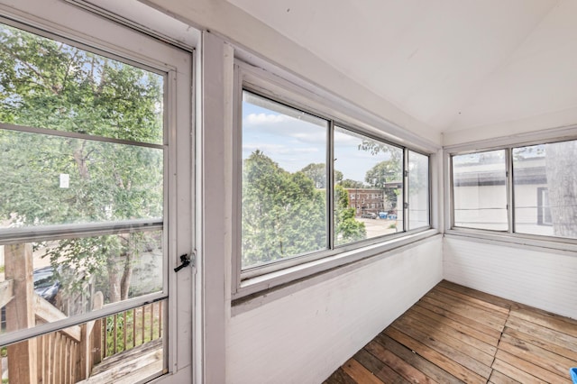 sunroom featuring vaulted ceiling