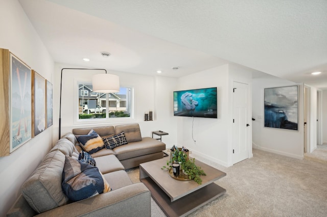 living area featuring recessed lighting, light colored carpet, and baseboards