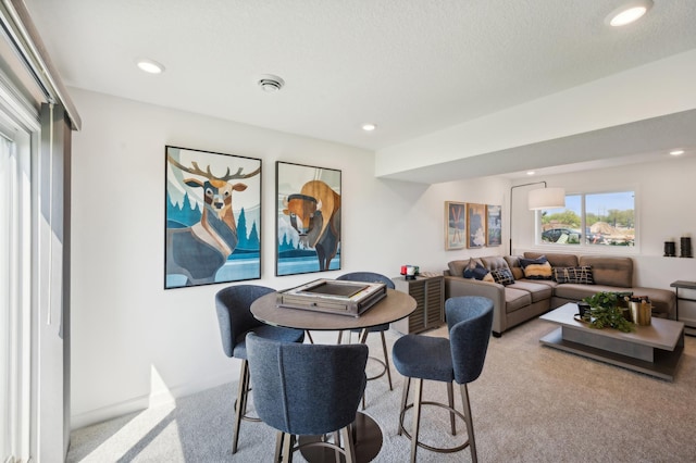 dining room featuring recessed lighting and carpet