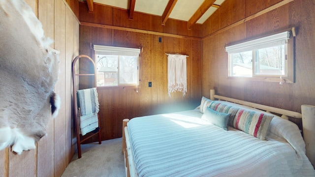 bedroom featuring light colored carpet and wood walls