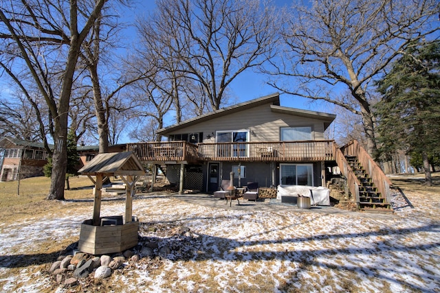 rear view of house featuring stairway and a wooden deck