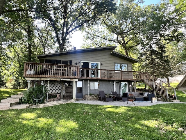 back of property featuring a yard, stairway, a patio, and a deck