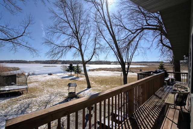 wooden terrace featuring a water view