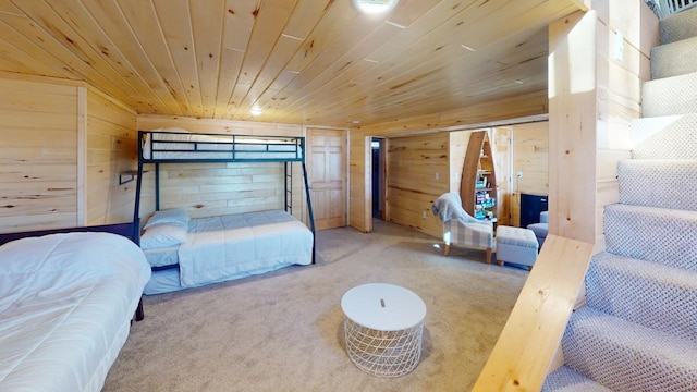 bedroom featuring wooden walls, wood ceiling, and carpet flooring