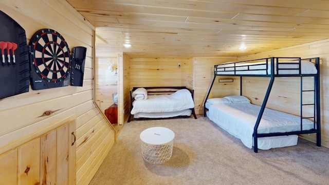 carpeted bedroom with wooden walls and wooden ceiling