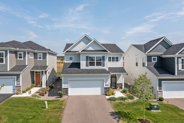 craftsman-style house featuring a garage, stone siding, a front lawn, and driveway