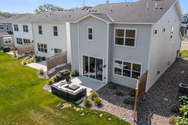 rear view of property with central air condition unit, a lawn, a patio, fence, and roof with shingles