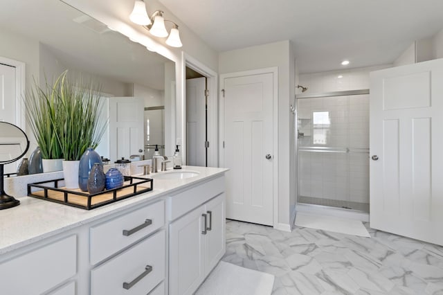 full bathroom with vanity, marble finish floor, and a shower stall