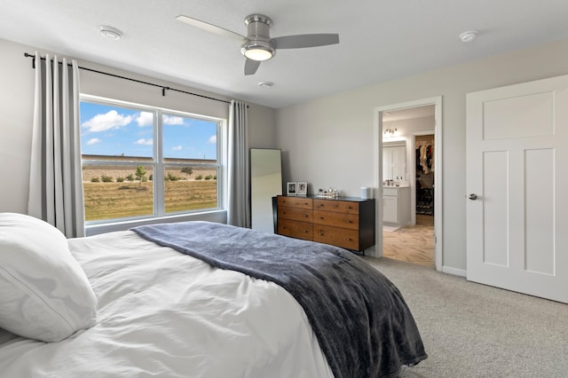 carpeted bedroom featuring a ceiling fan and baseboards