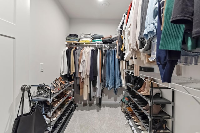 walk in closet featuring carpet