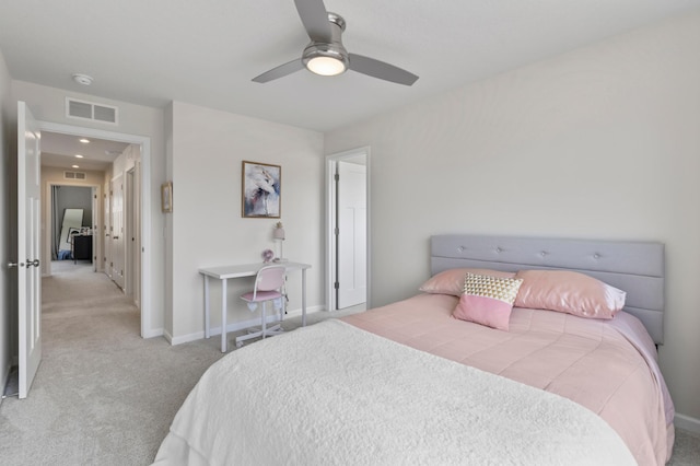 carpeted bedroom with visible vents, a ceiling fan, and baseboards