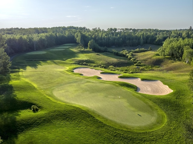 surrounding community featuring a wooded view and golf course view